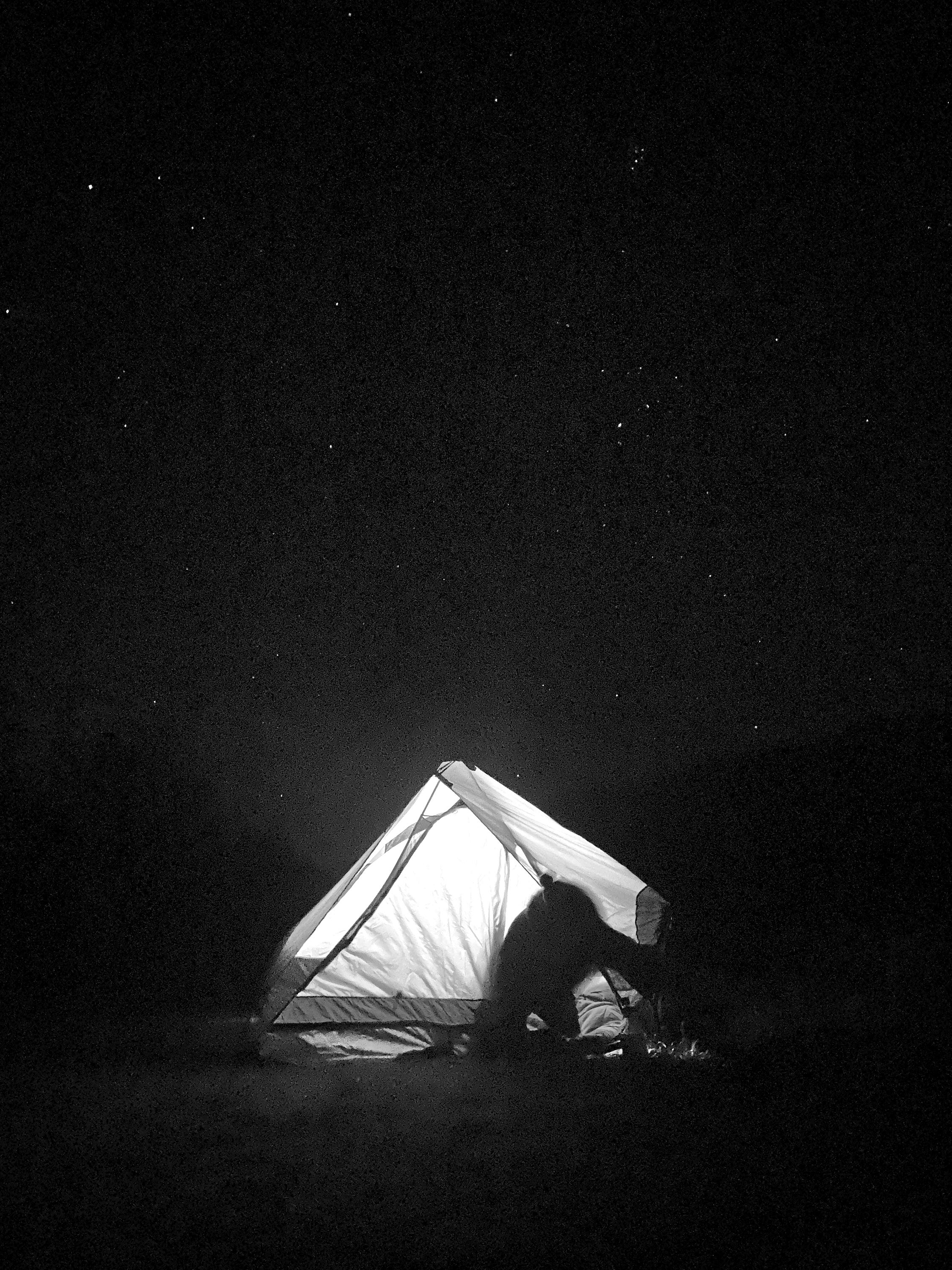 A tent illuminated under the stars